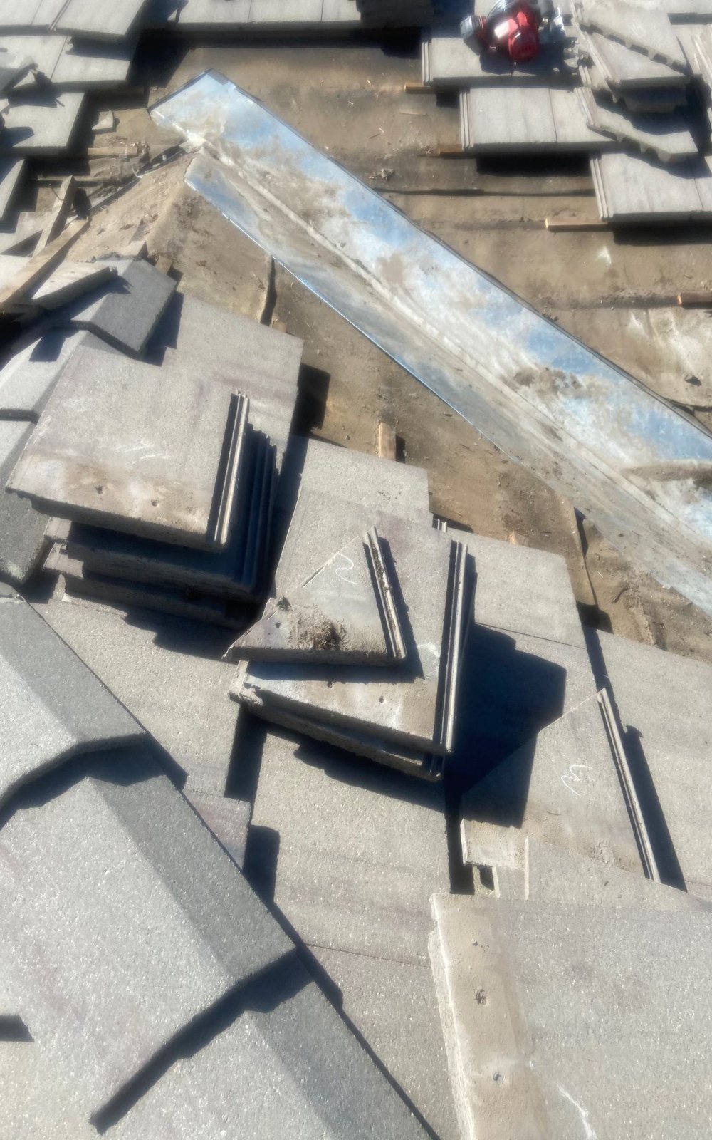 Close inspection of hail-damaged asphalt shingles in Parker