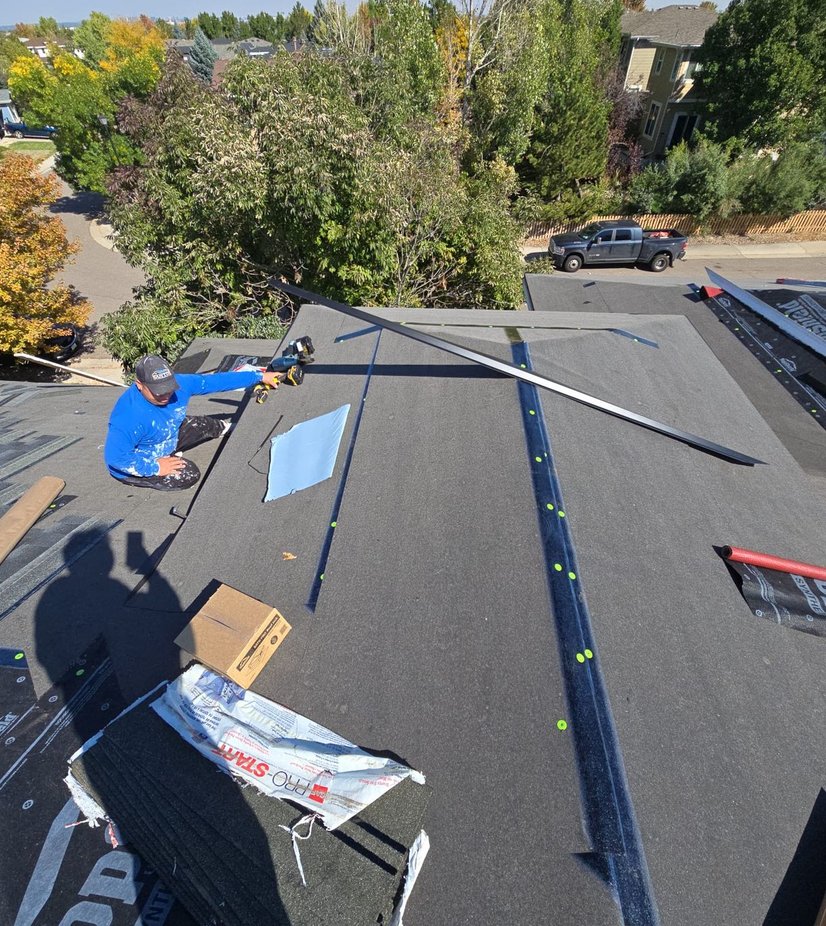 Steadfast installer setting drip edge during a roof replacement